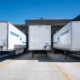 three white enclosed trailers
